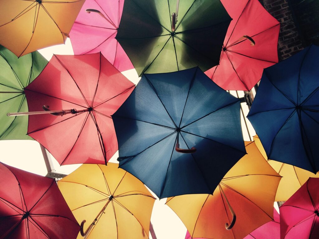 Vibrant umbrellas create a colorful canopy offering protection, just like laddering life insurance