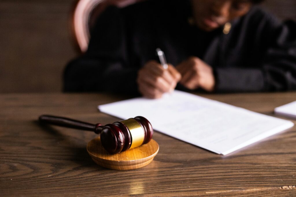 Judge signing documents at desk with focus on gavel, representing law and justice and why probate sucks