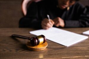 Judge signing documents at desk with focus on gavel, representing law and justice and why probate sucks