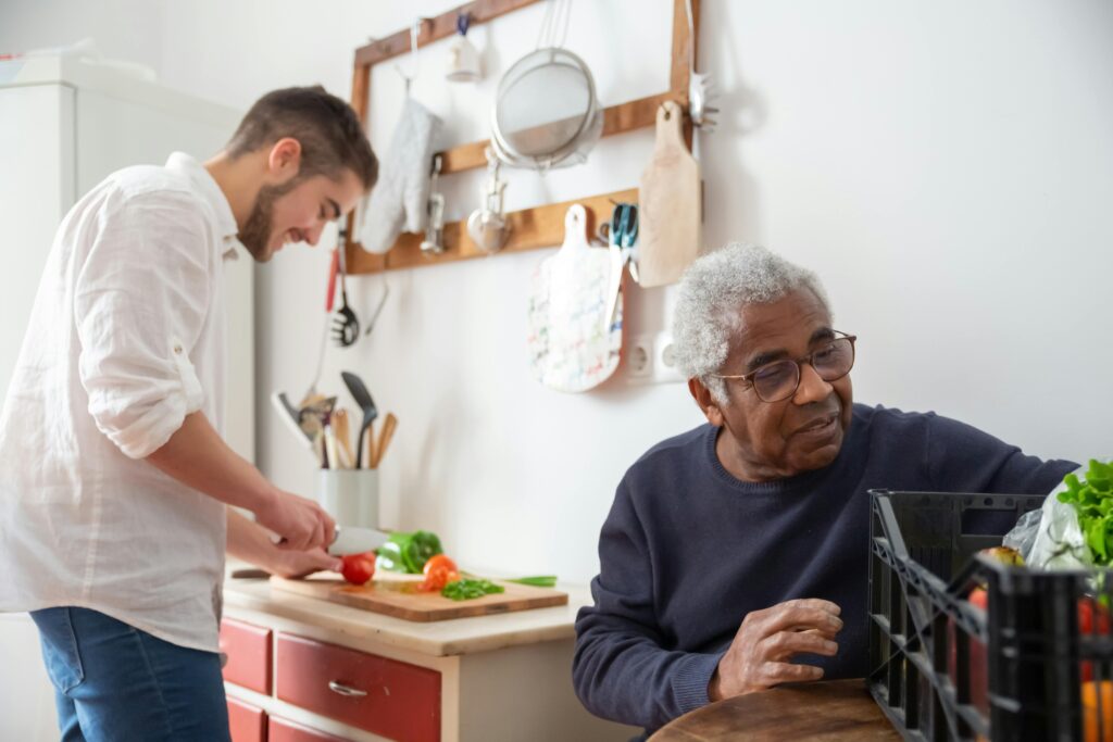 Man helping Senior man prepare food, signs aging parents need help