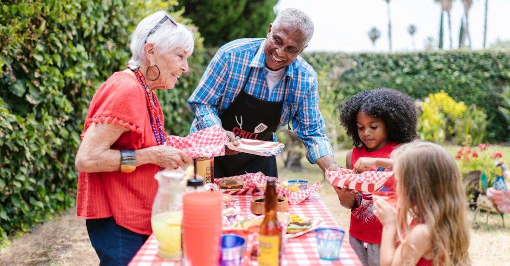 A joyful family gathers outdoors for a picnic, enjoying food and togetherness.