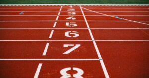 Close-up view of an athletic race track with numbered lanes, ready for competition.